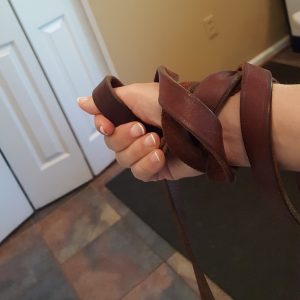 Dog leash held incorrectly, wound around the person's wrist