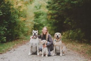 Dog trainer and three dogs